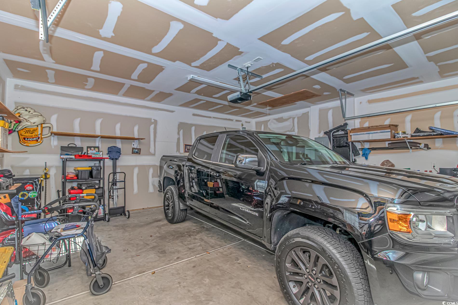 139 Chenoa Drive, Unit D Murrells Inlet, SC 29576 - Photo 26 of 34 Garage featuring a garage door opener