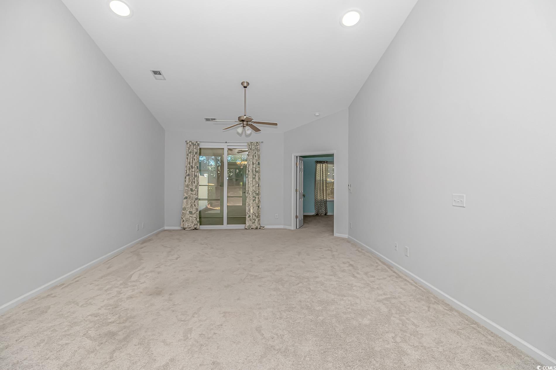 139 Chenoa Drive, Unit D Murrells Inlet, SC 29576 - Photo 10 of 34 Carpeted empty room featuring ceiling fan and vaulted ceiling
