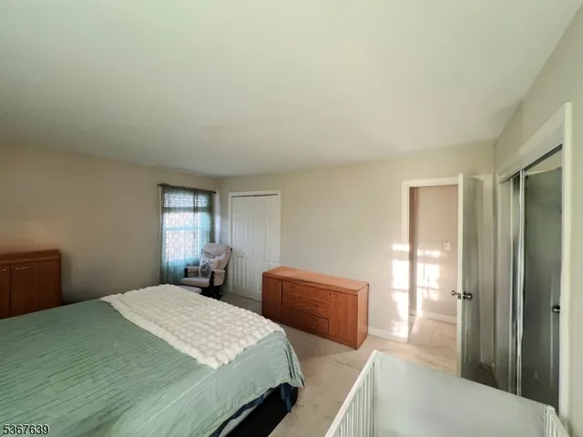 a bedroom with a bed and a large mirror