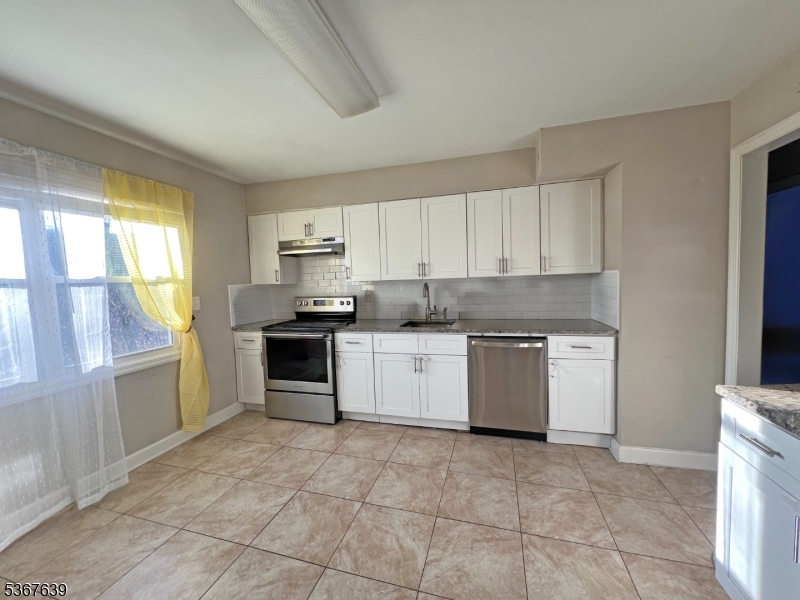 29 Billings Road Hopatcong, NJ 07843 - Photo 9 of 14 a kitchen with a stove top oven sink and cabinets