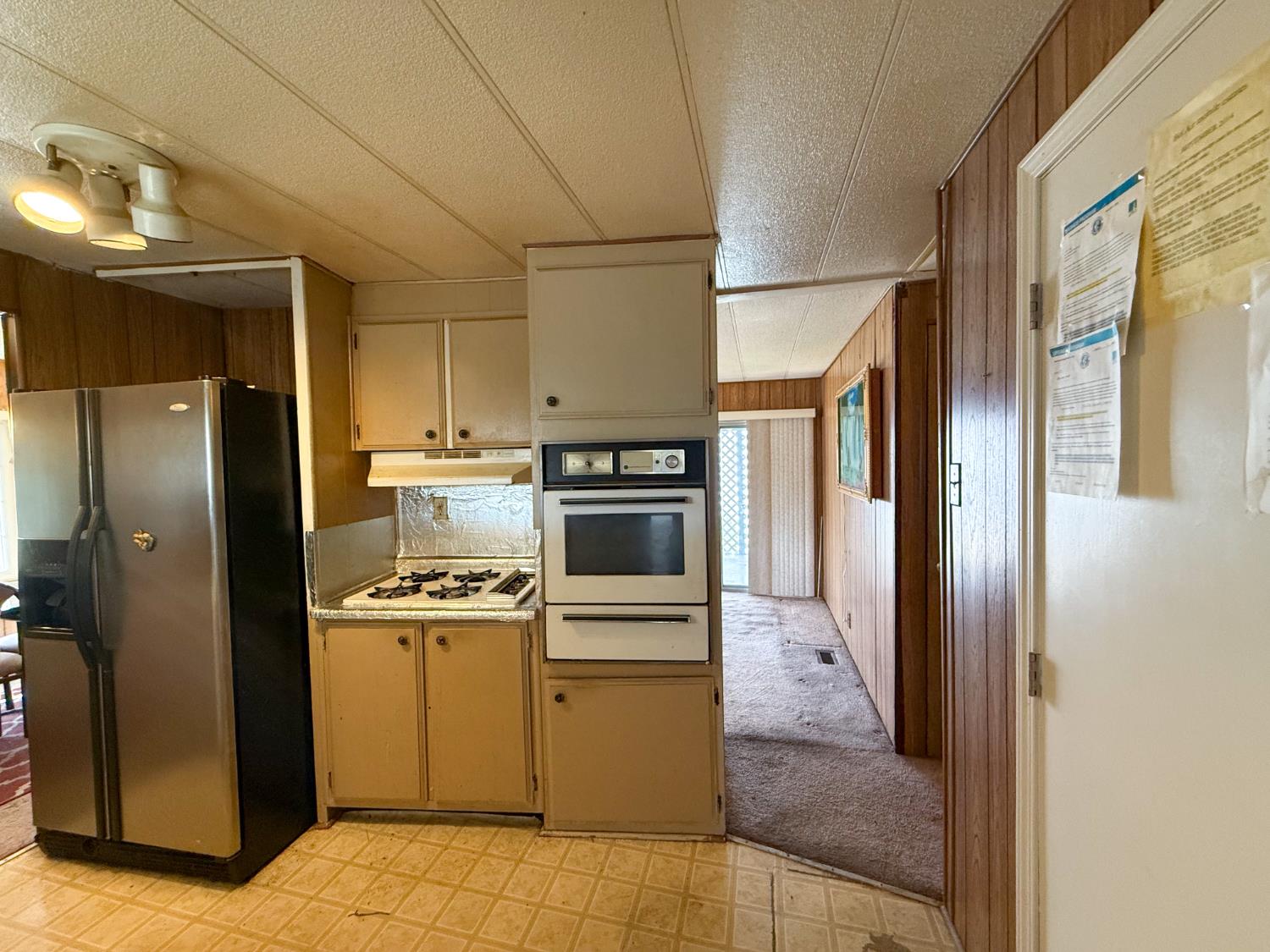5835 Cherokee Road, Unit 41 Stockton, CA 95215 - Photo 11 of 35 a kitchen with a stove cabinets and refrigerator