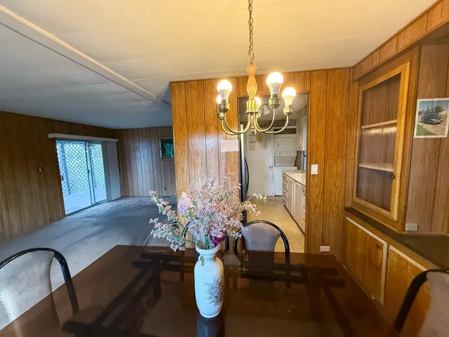 a view of a dining room with furniture and chandelier