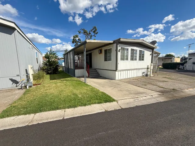 a front view of a house with a garden and yard
