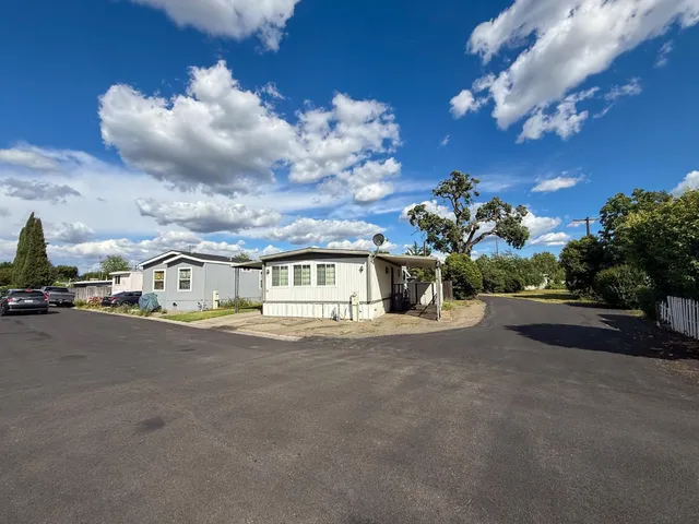 a view of a house with a yard and garage