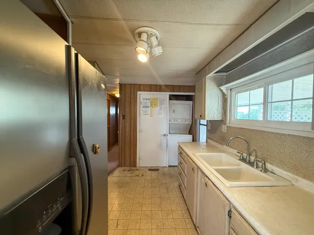 a bathroom with a tub sink and mirror
