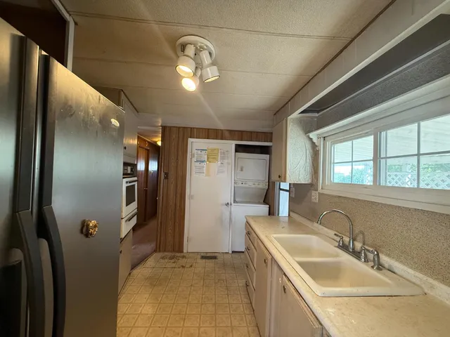 a bathroom with a sink a large mirror and shower