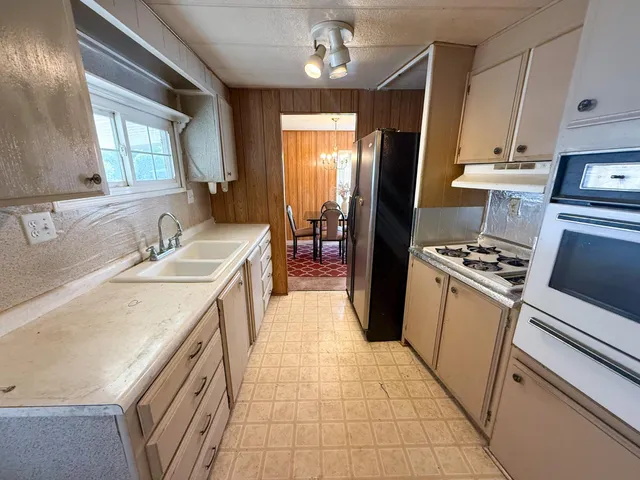 a kitchen with a sink stove and refrigerator