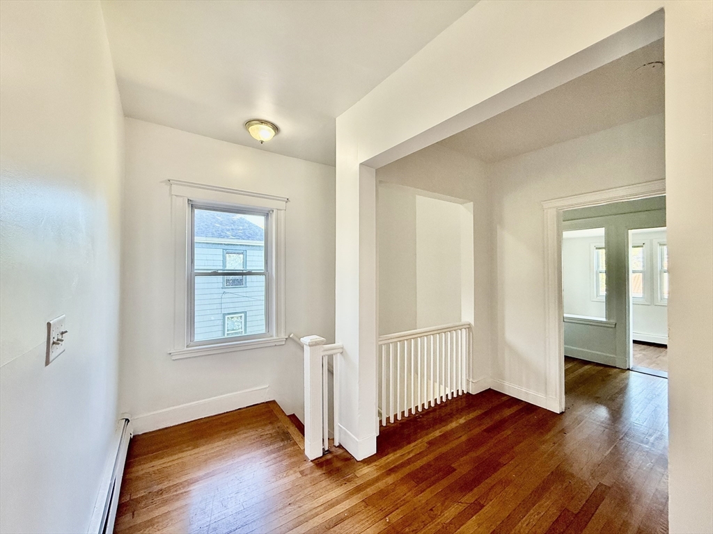 62 Algonquin Road, Unit 2 Newton, MA 02467 - Photo 13 of 38 an empty room with wooden floor and windows