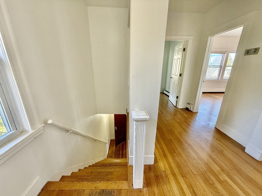 62 Algonquin Road, Unit 2 Newton, MA 02467 - Photo 34 of 38 a view of a hallway with wooden floor and staircase
