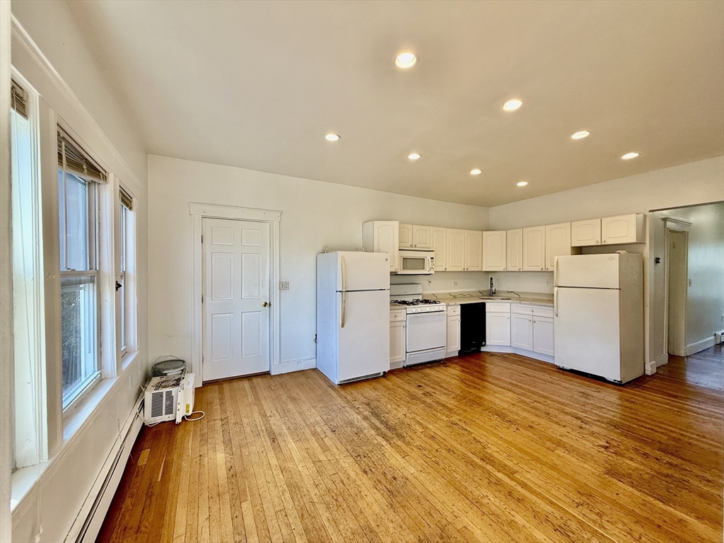 62 Algonquin Road, Unit 2 Newton, MA 02467 - Photo 5 of 38 a kitchen with stainless steel appliances a refrigerator and wooden floor