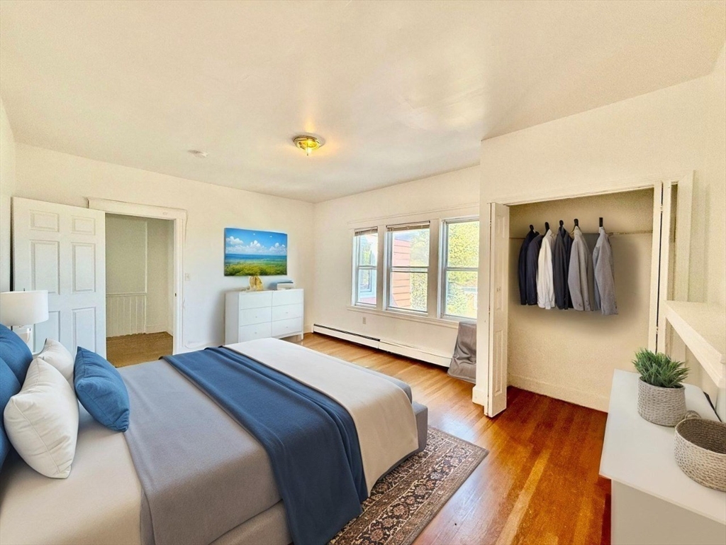 62 Algonquin Road, Unit 2 Newton, MA 02467 - Photo 8 of 38 a bedroom with a bed and wooden floor