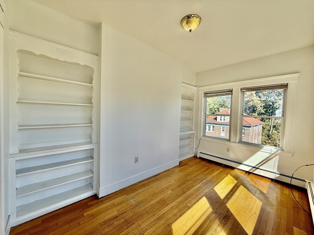 62 Algonquin Road, Unit 2 Newton, MA 02467 - Photo 10 of 38 a view of room with window and wooden floor