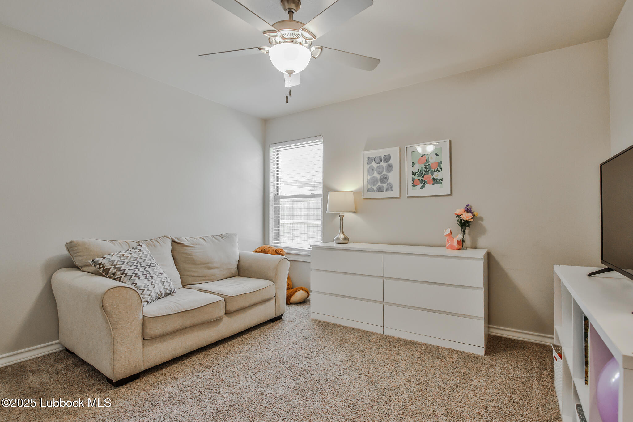5221 Jarvis Street Lubbock, TX 79416 - Photo 12 of 22 a living room with furniture and a flat screen tv