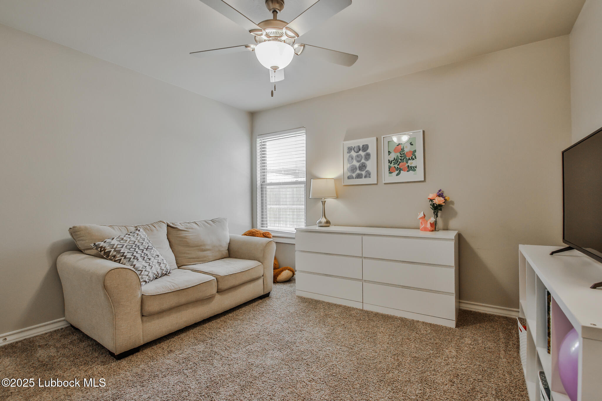 5221 Jarvis Street Lubbock, TX 79416 - Photo 13 of 22 a living room with furniture and a flat screen tv
