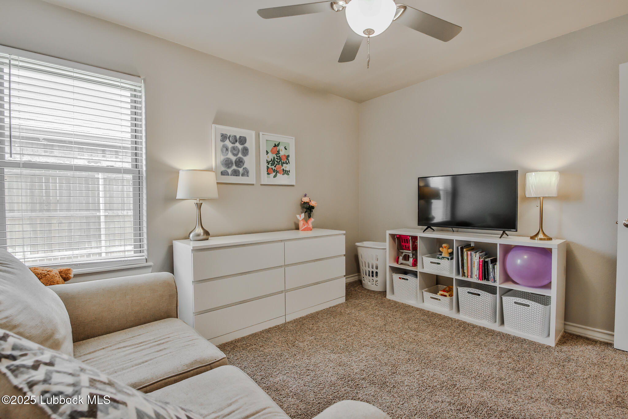 5221 Jarvis Street Lubbock, TX 79416 - Photo 14 of 22 a living room with furniture and a flat screen tv