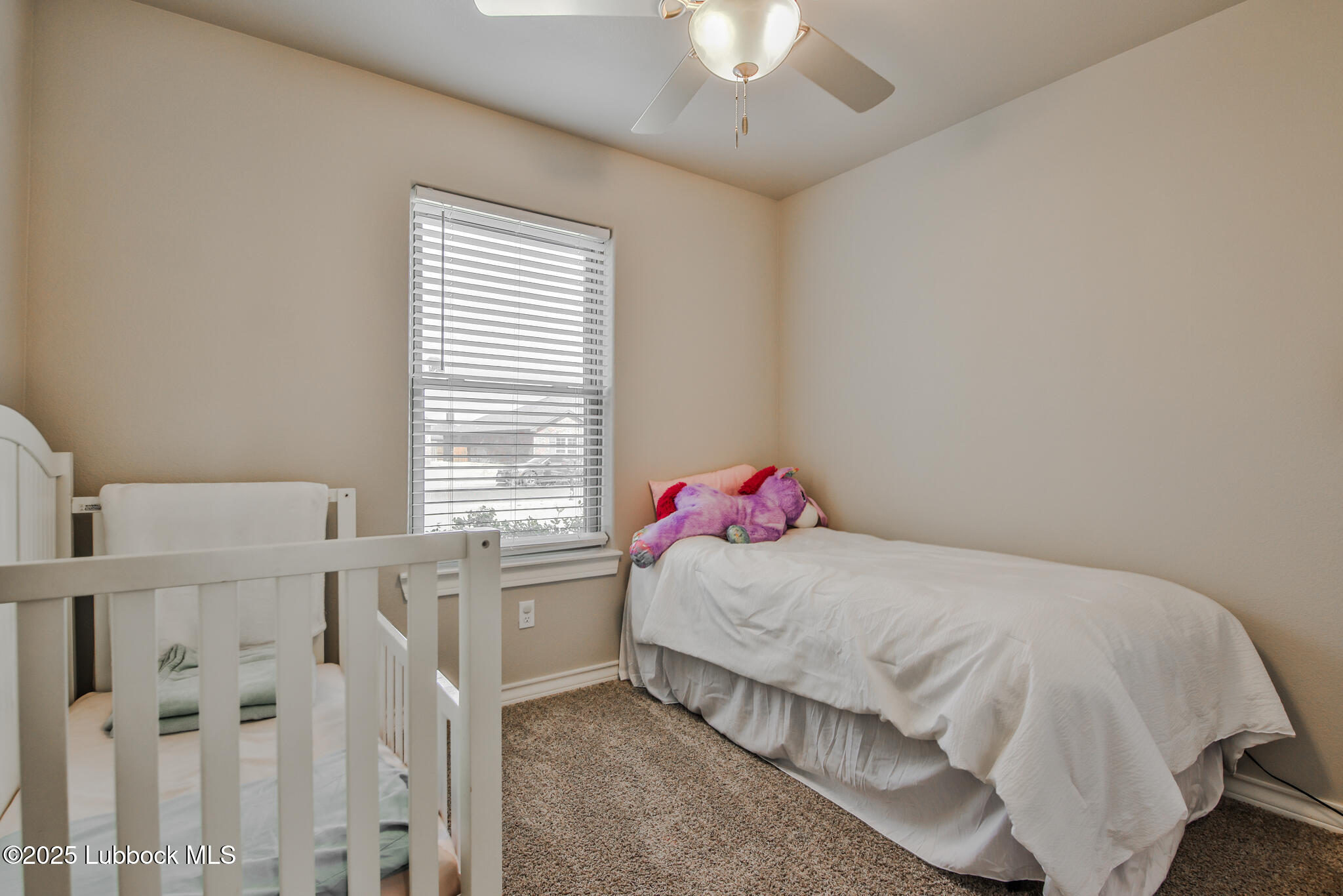 5221 Jarvis Street Lubbock, TX 79416 - Photo 2 of 22 a bedroom with a bed and a chandelier