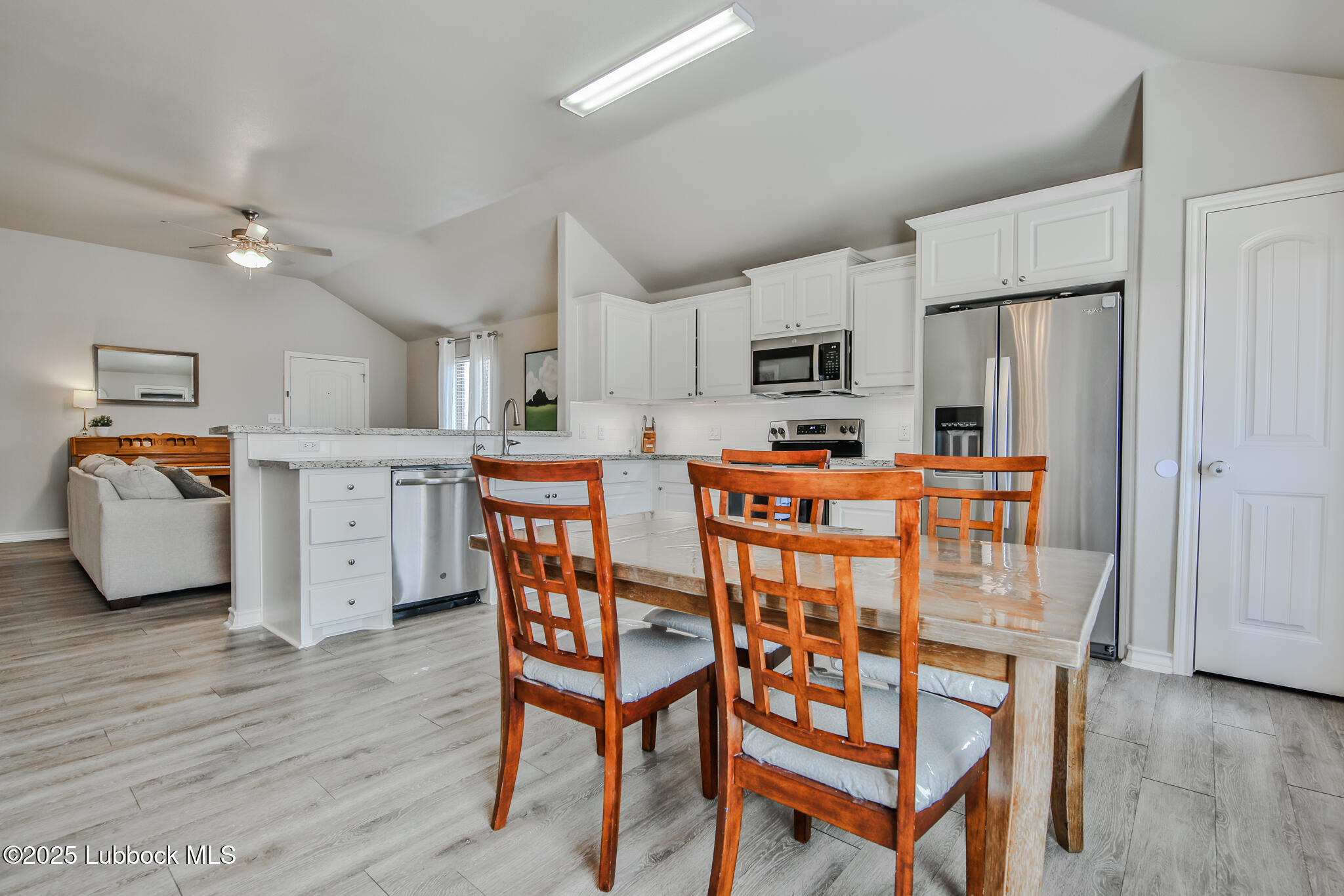 5221 Jarvis Street Lubbock, TX 79416 - Photo 22 of 22 a kitchen with stainless steel appliances granite countertop a white table and chairs