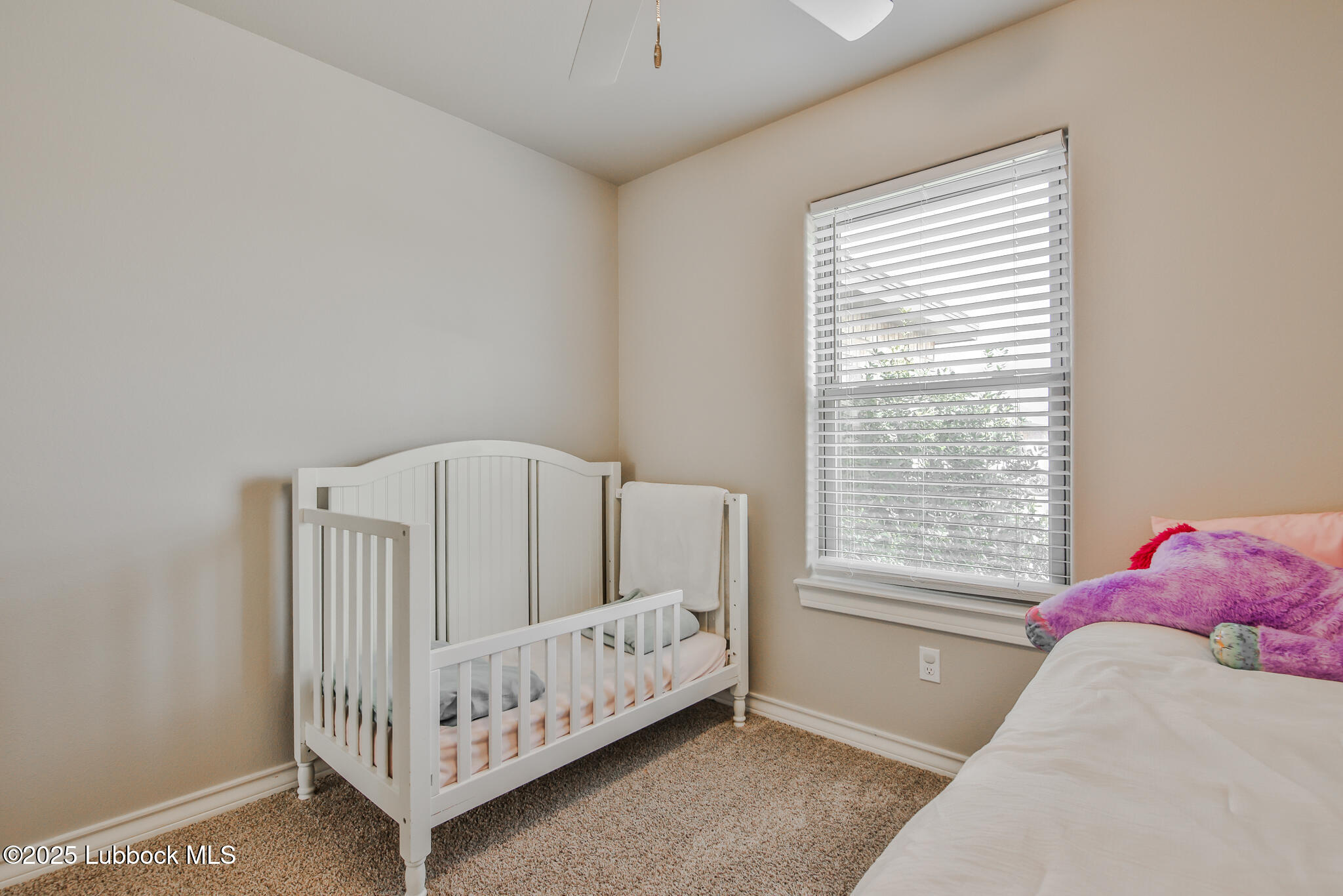 5221 Jarvis Street Lubbock, TX 79416 - Photo 3 of 22 a bedroom with a bed and a window