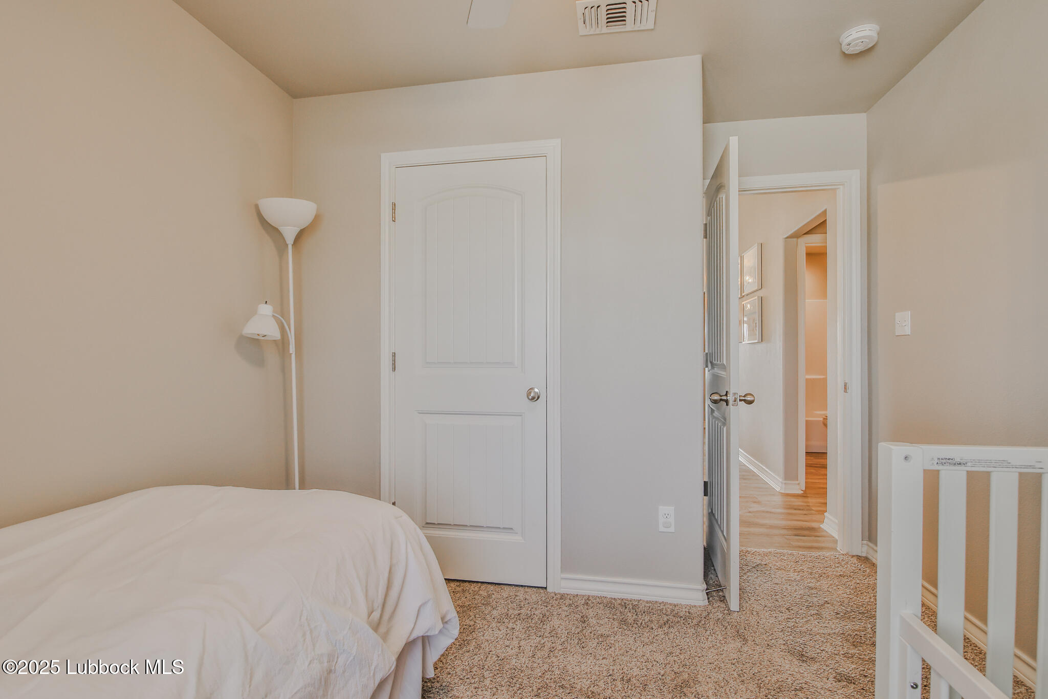 5221 Jarvis Street Lubbock, TX 79416 - Photo 4 of 22 a bedroom with a bed and hallway