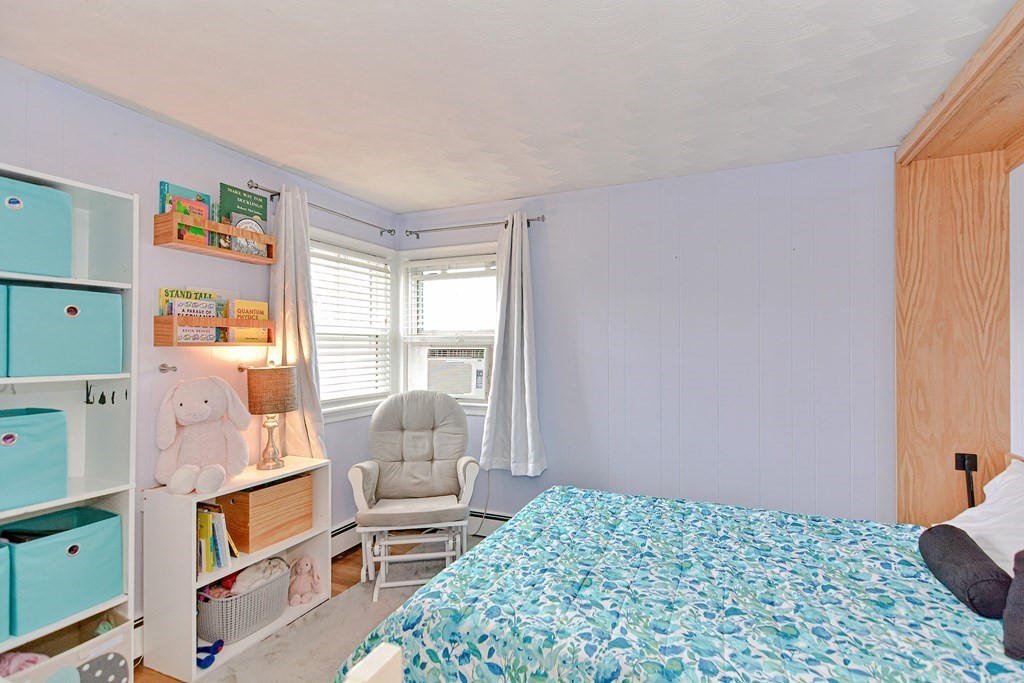 9 Doane Road Medford, MA 02155 - Photo 17 of 28 a bedroom with a bed and wooden floor