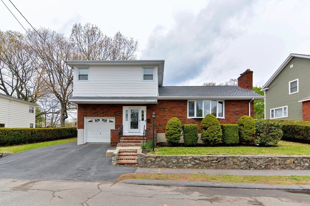 9 Doane Road Medford, MA 02155 - Photo 2 of 28 a front view of a house with a garden