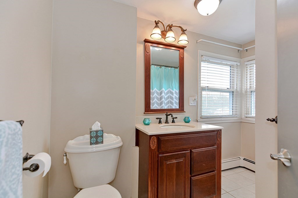 9 Doane Road Medford, MA 02155 - Photo 21 of 28 a bathroom with a toilet sink and mirror