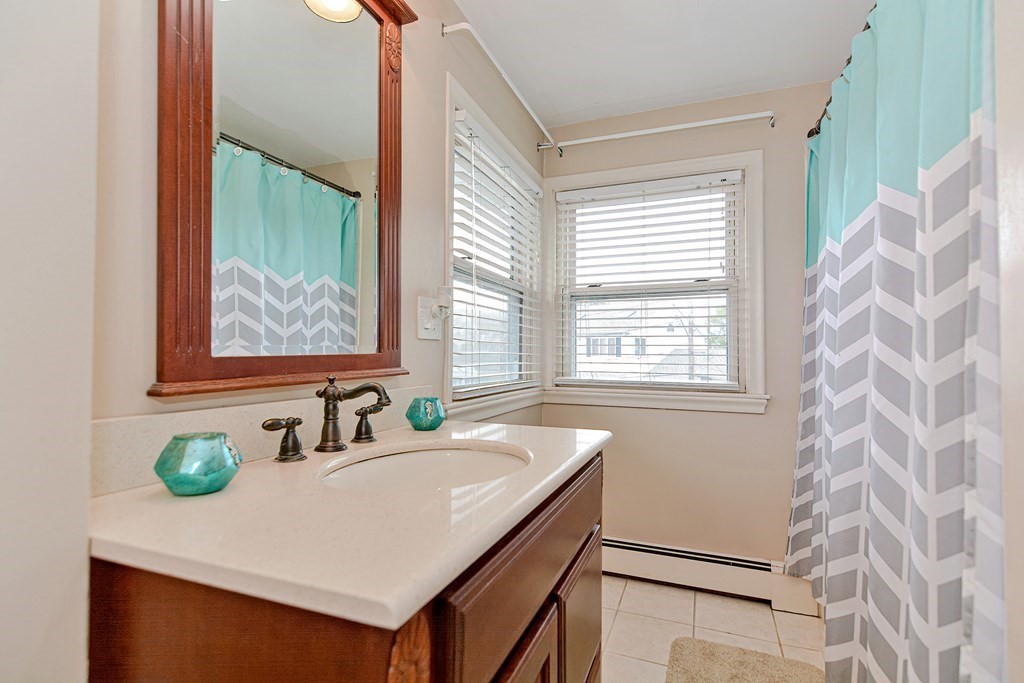 9 Doane Road Medford, MA 02155 - Photo 22 of 28 a bathroom with a sink and a mirror