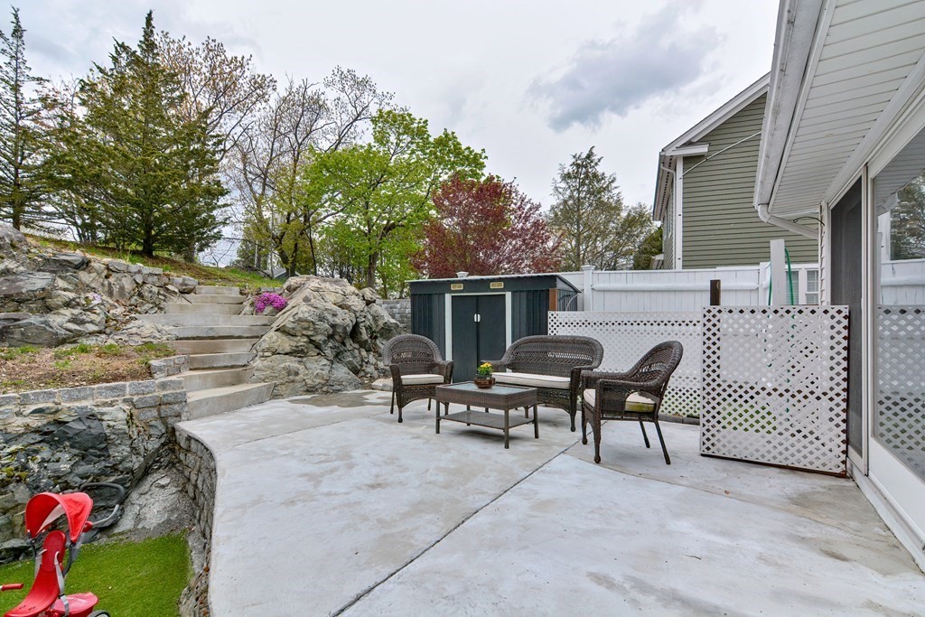 9 Doane Road Medford, MA 02155 - Photo 27 of 28 a view of a patio with table and chairs and potted plants