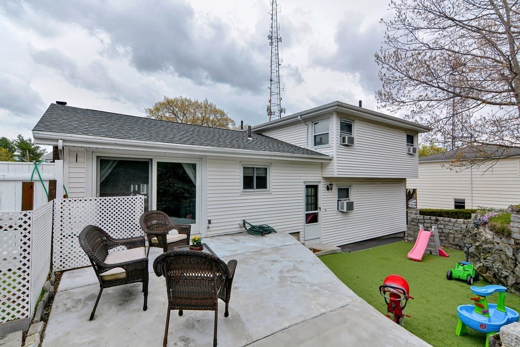 9 Doane Road Medford, MA 02155 - Photo 28 of 28 a backyard of a house with table and chairs