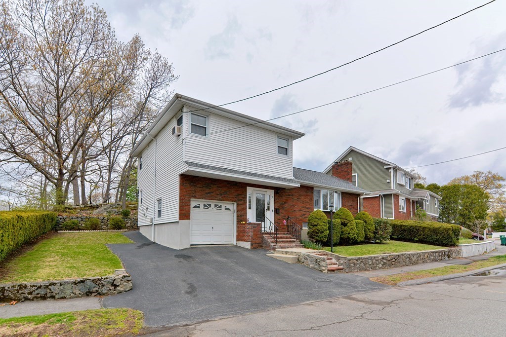 9 Doane Road Medford, MA 02155 - Photo 3 of 28 a front view of a house with garden