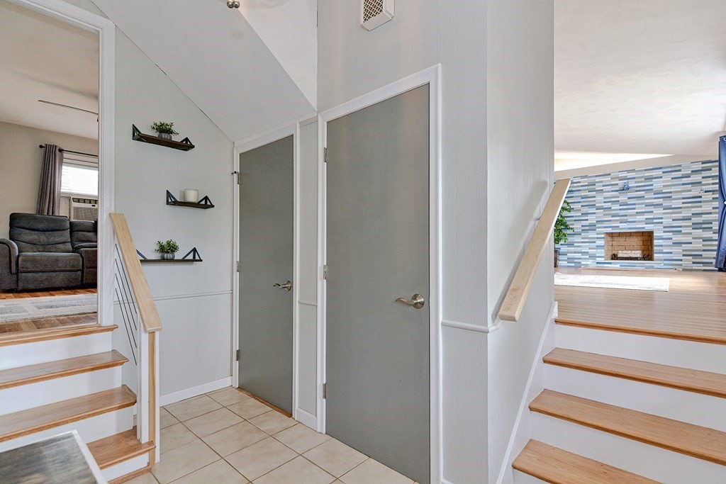 9 Doane Road Medford, MA 02155 - Photo 4 of 28 a view of a hallway with wooden floor and staircase