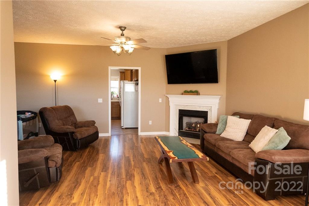 565 Salem Church Road Bostic, NC 28018 - Photo 17 of 44 a living room with furniture a flat screen tv and a fireplace