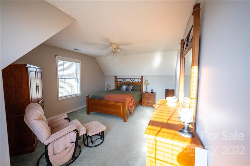 565 Salem Church Road Bostic, NC 28018 - Photo 32 of 44 a bedroom with a bed and a chandelier