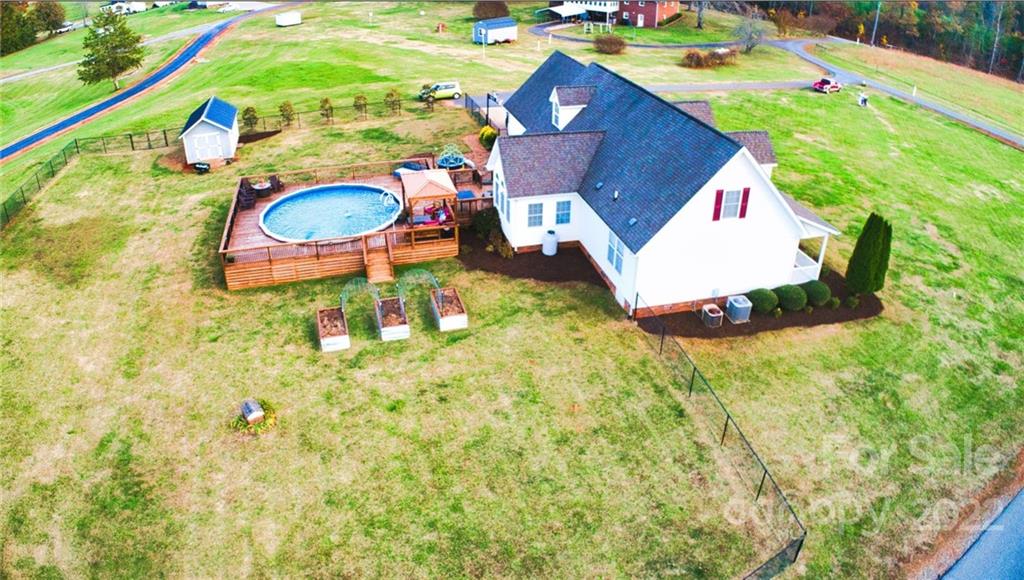 565 Salem Church Road Bostic, NC 28018 - Photo 5 of 44 a aerial view of a house with swimming pool and large trees