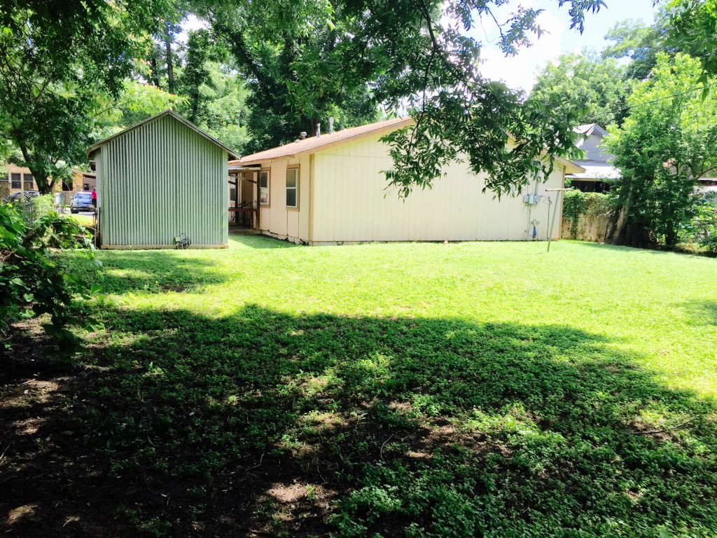 a view of a backyard with large trees