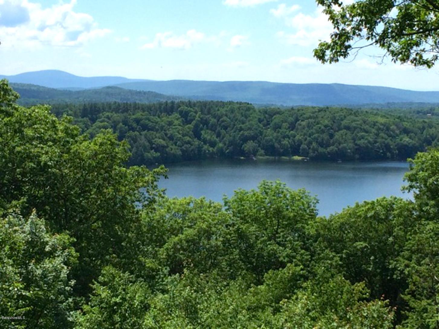 116 Hupi Road Monterey, MA 01245 - Photo 1 of 17 an aerial view of green landscape with trees houses and mountain view