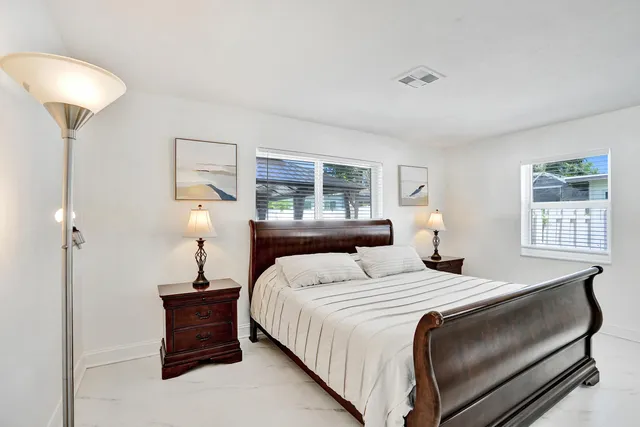 a bedroom with a bed and a lamp