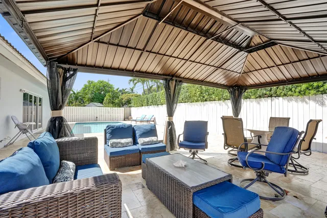 a view of a chair and table in the backyard