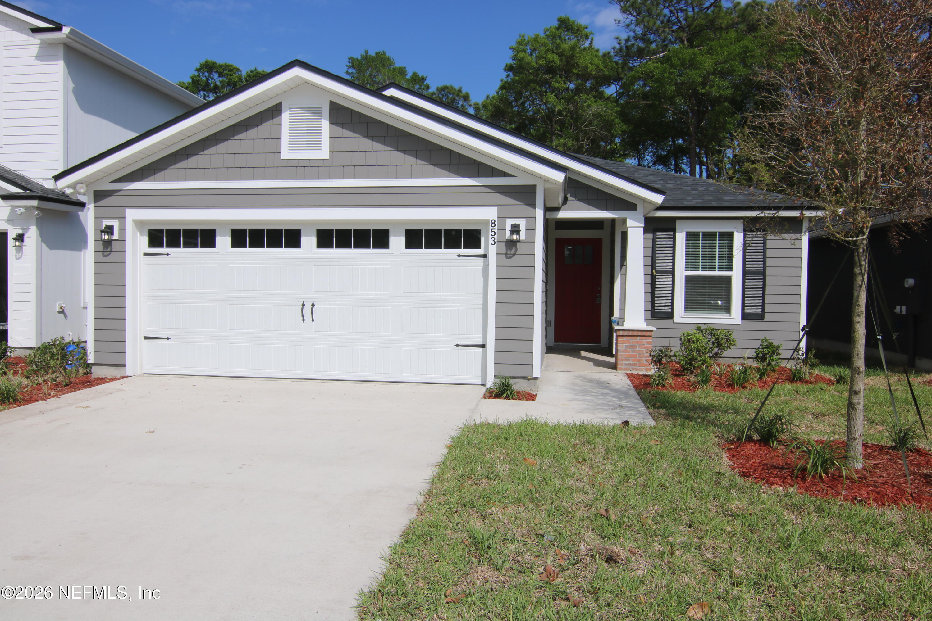 853 Jackson Road Jacksonville, FL 32225 - Photo 1 of 18 a front view of a house with a yard and garage