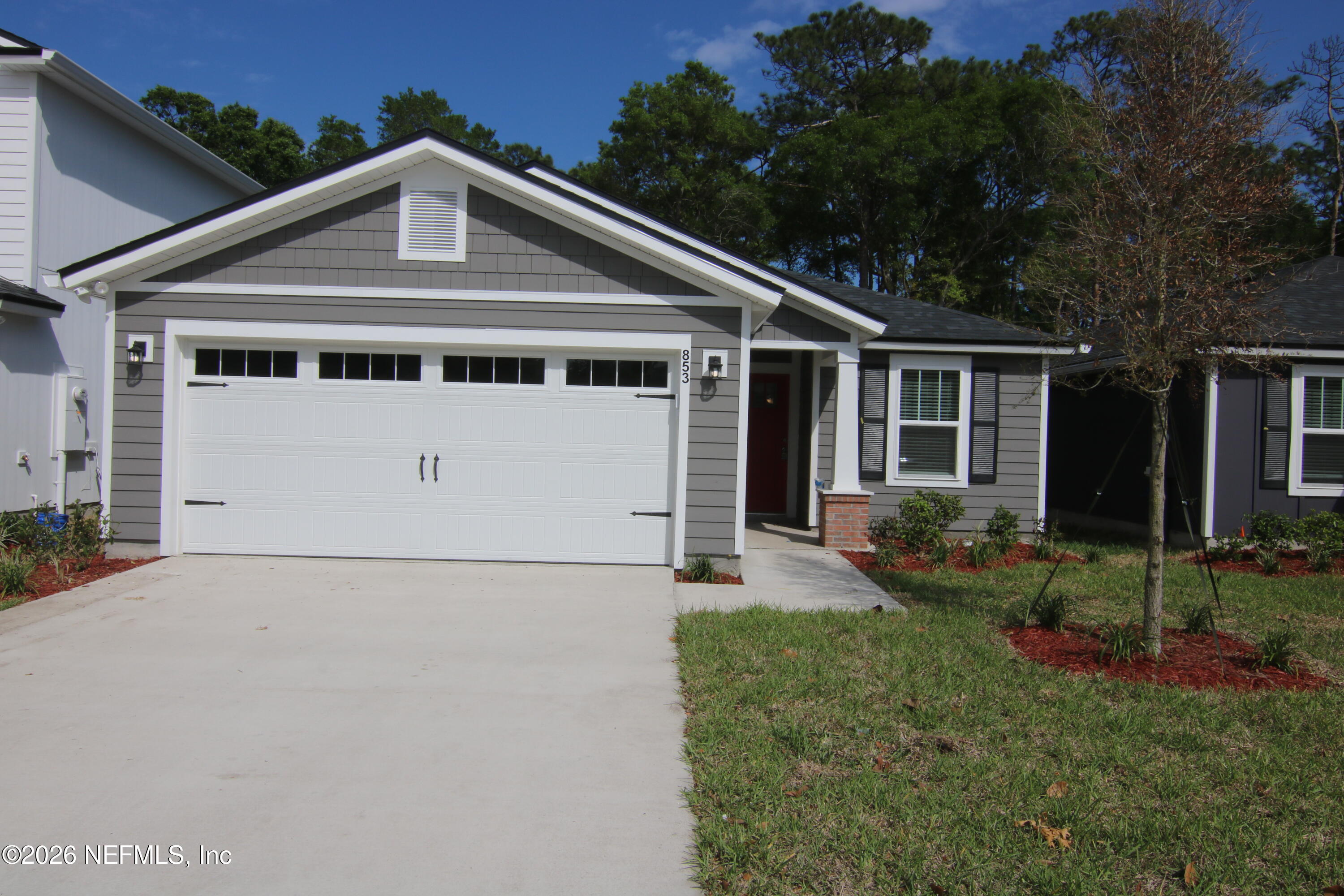 853 Jackson Road Jacksonville, FL 32225 - Photo 18 of 18 a front view of a house with a yard and potted plants