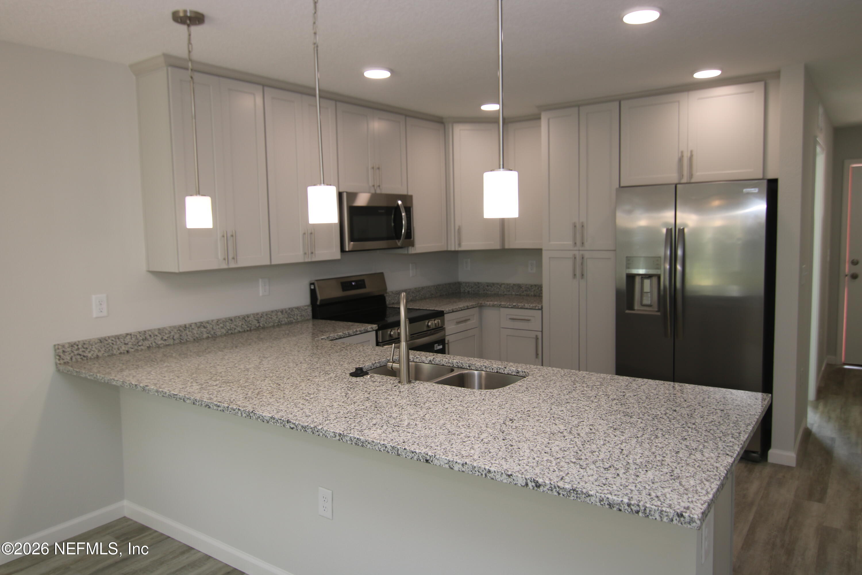 853 Jackson Road Jacksonville, FL 32225 - Photo 6 of 18 a kitchen with kitchen island a sink stainless steel appliances and a counter top space