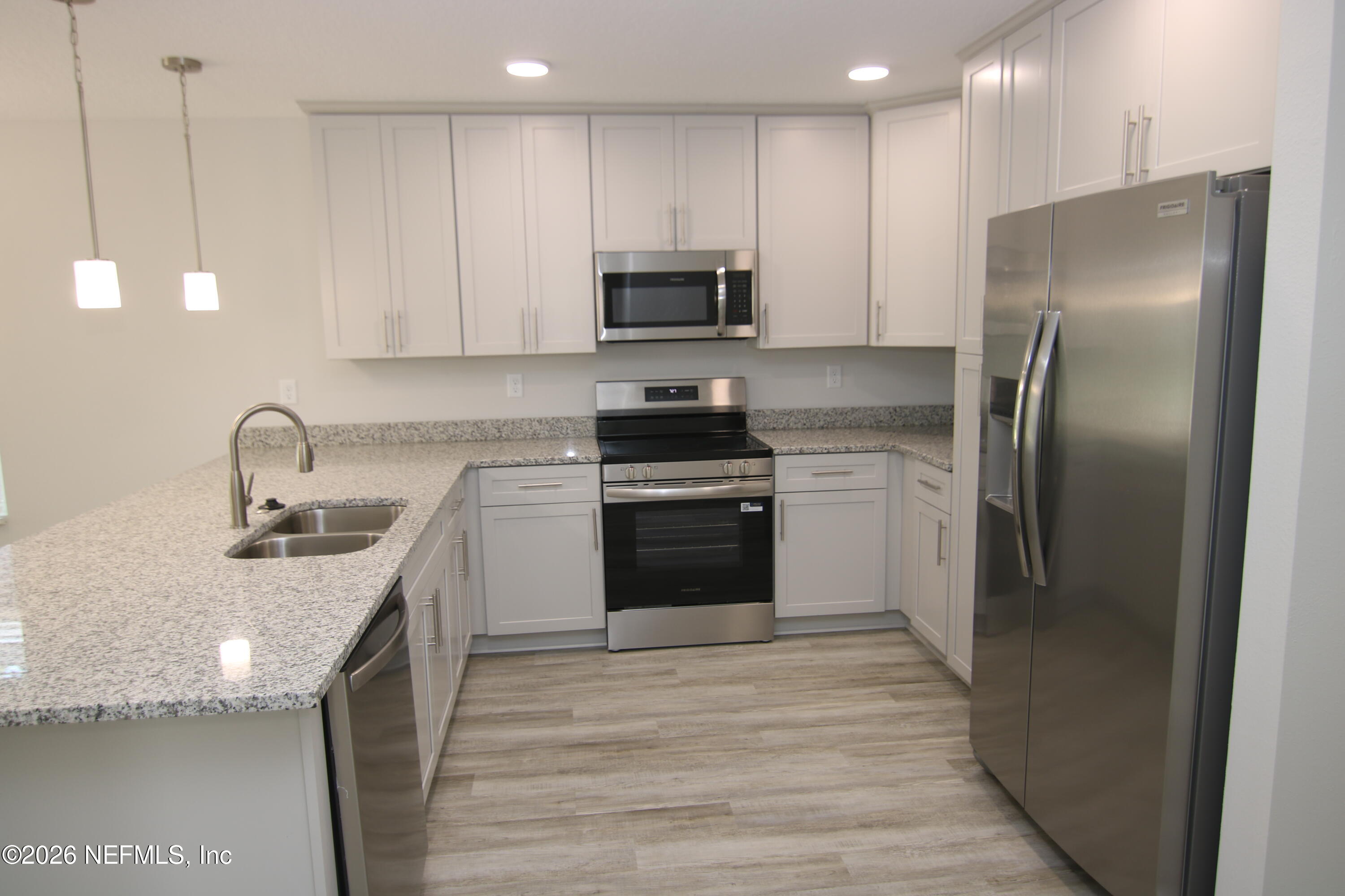 853 Jackson Road Jacksonville, FL 32225 - Photo 7 of 18 a kitchen with stainless steel appliances granite countertop a refrigerator sink and stove