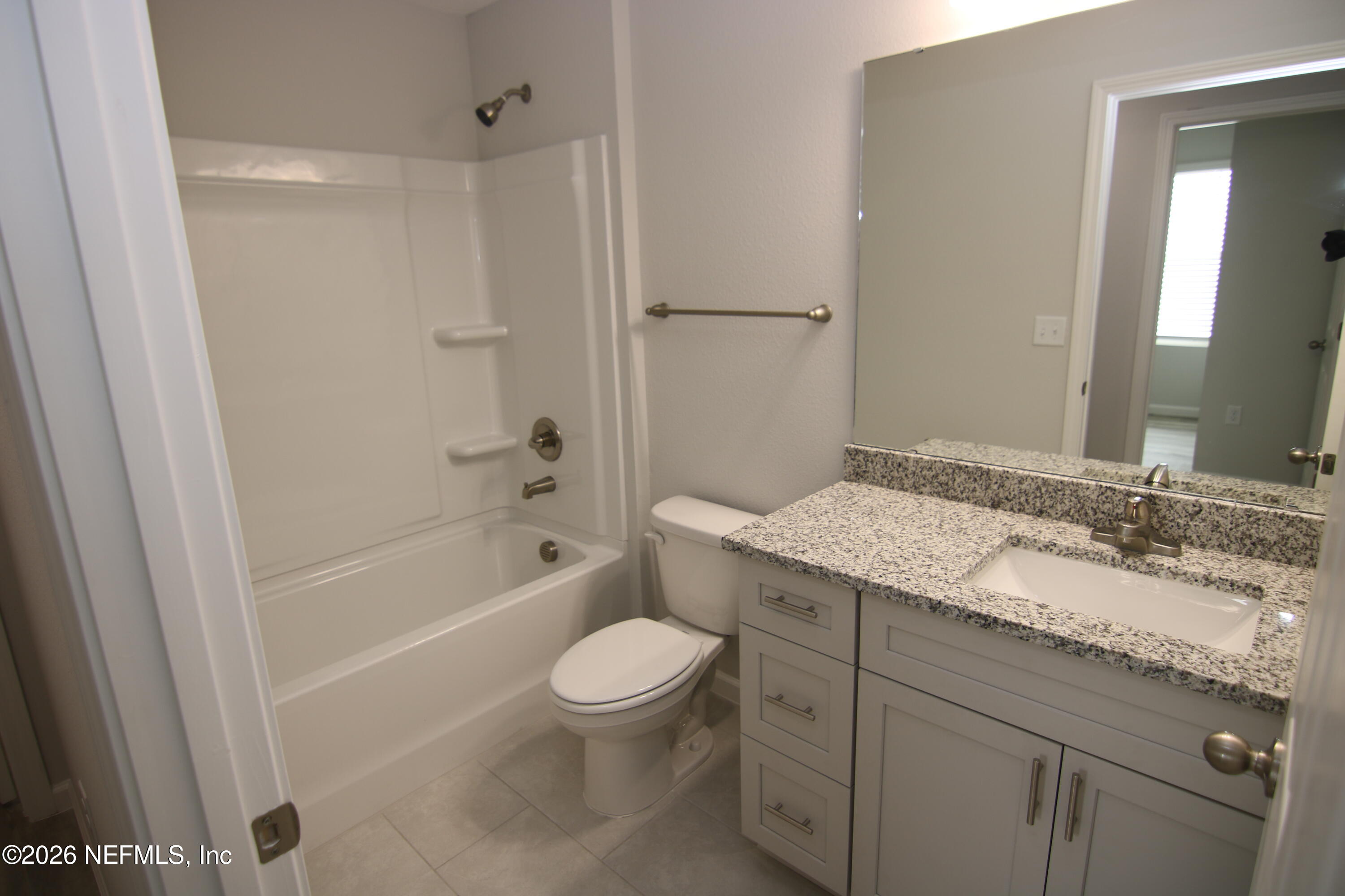 853 Jackson Road Jacksonville, FL 32225 - Photo 9 of 18 a bathroom with a granite countertop sink toilet and shower