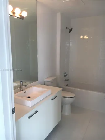 a kitchen with cabinets and stainless steel appliances