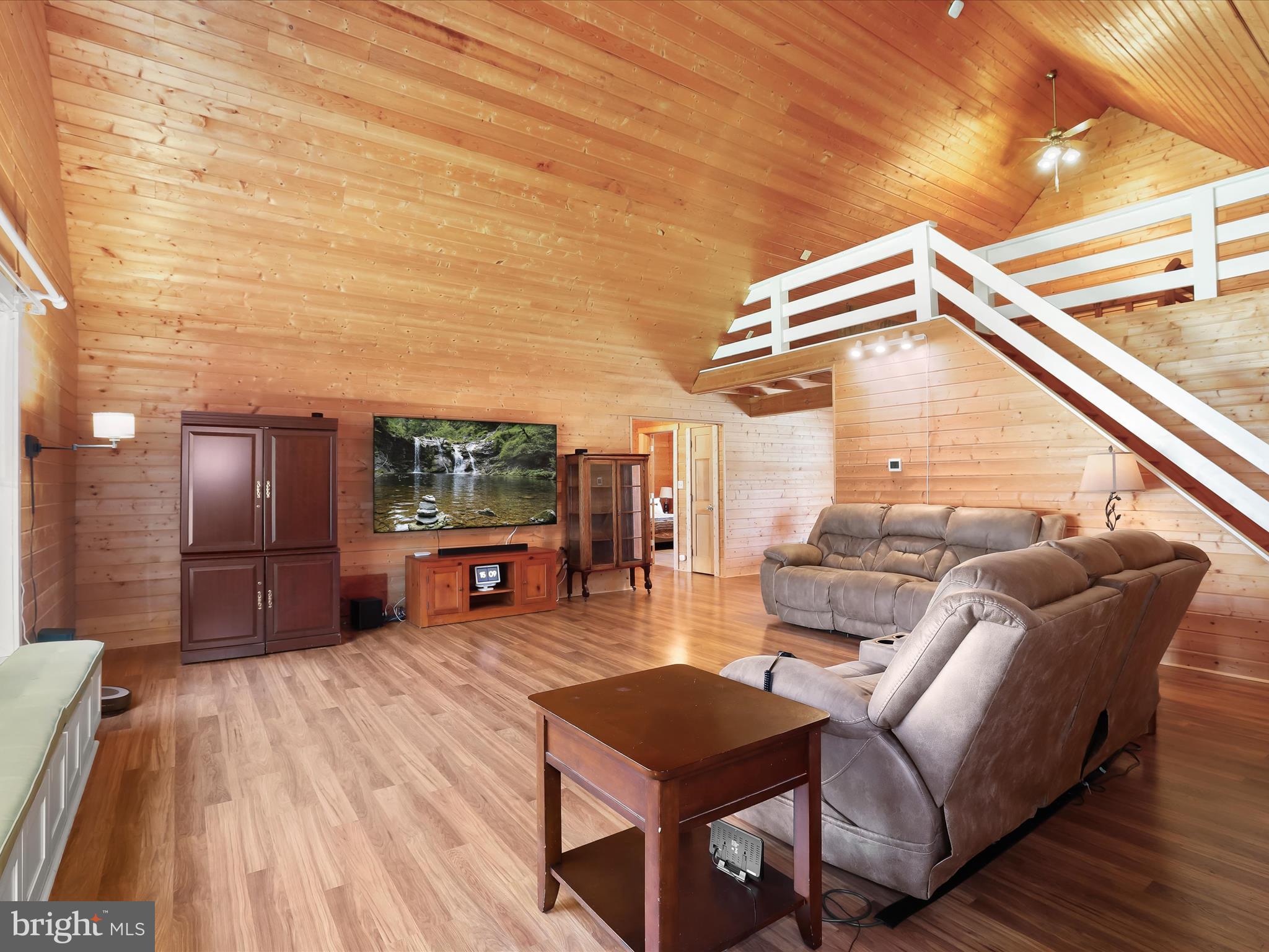 Main living area with a soaring cathedral ceiling
