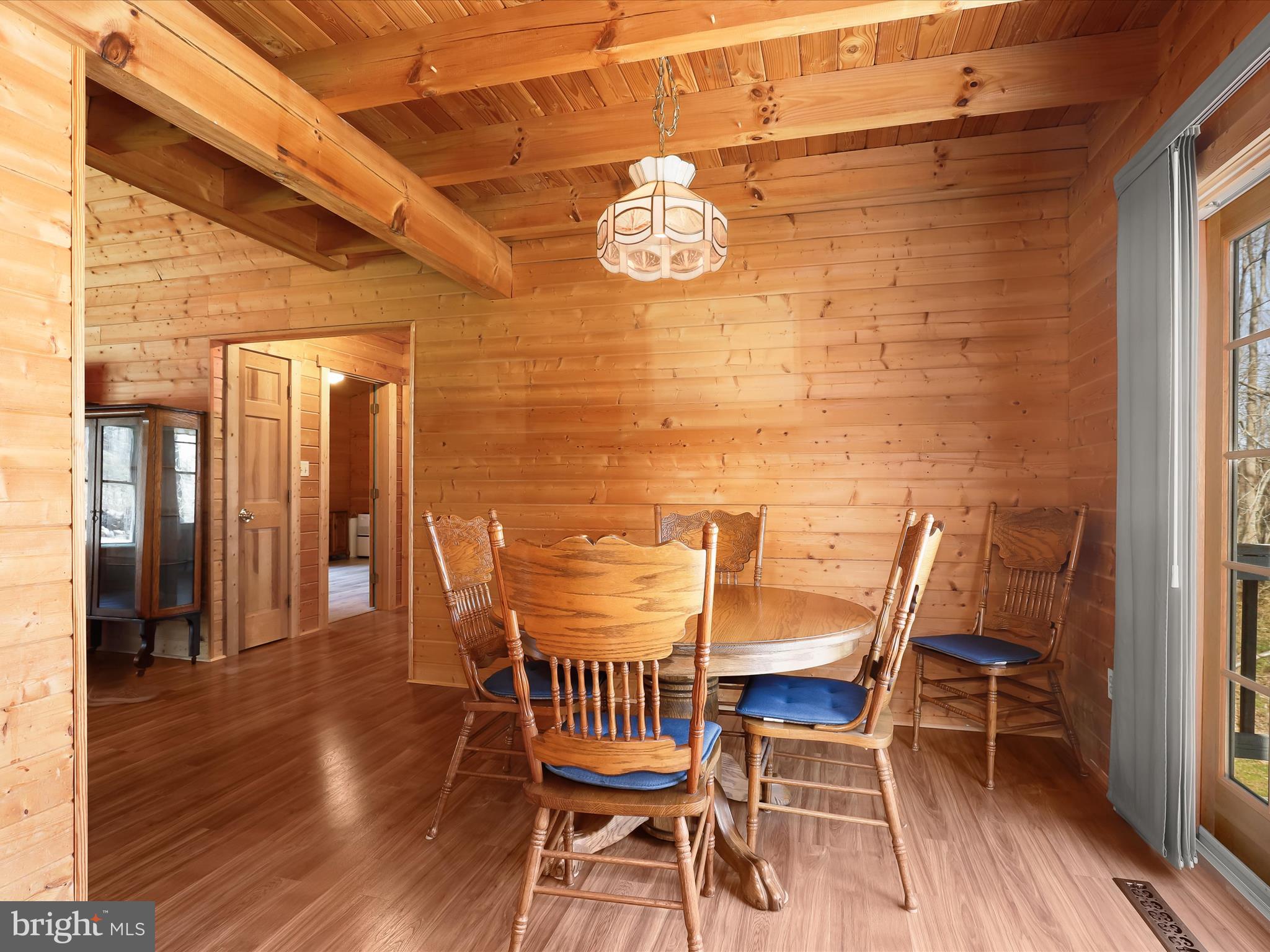Dining room highlights exposed beam ceiling