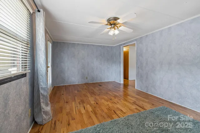 a view of an empty room and wooden floor