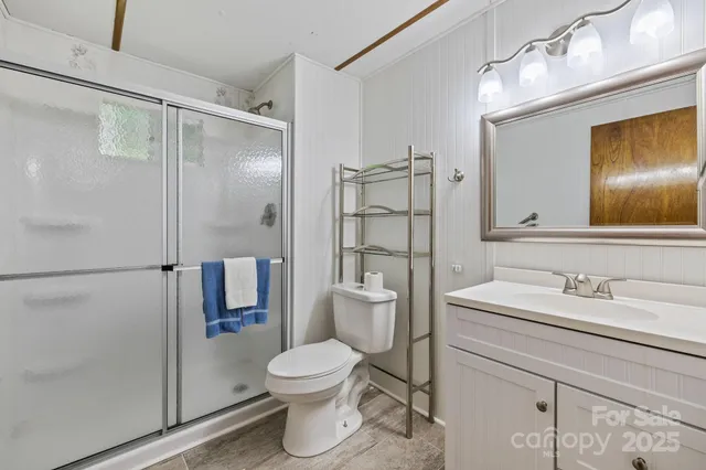 a bathroom with a granite countertop toilet sink and shower