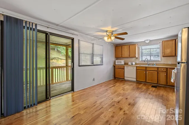 a view of a kitchen with a sink a refrigerator and window