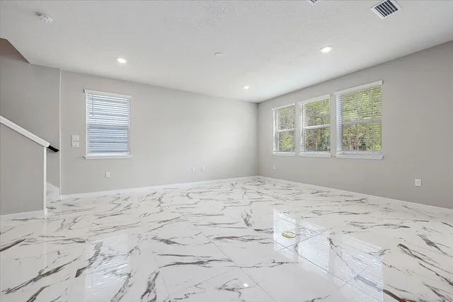 a big room with a bed and wooden floor